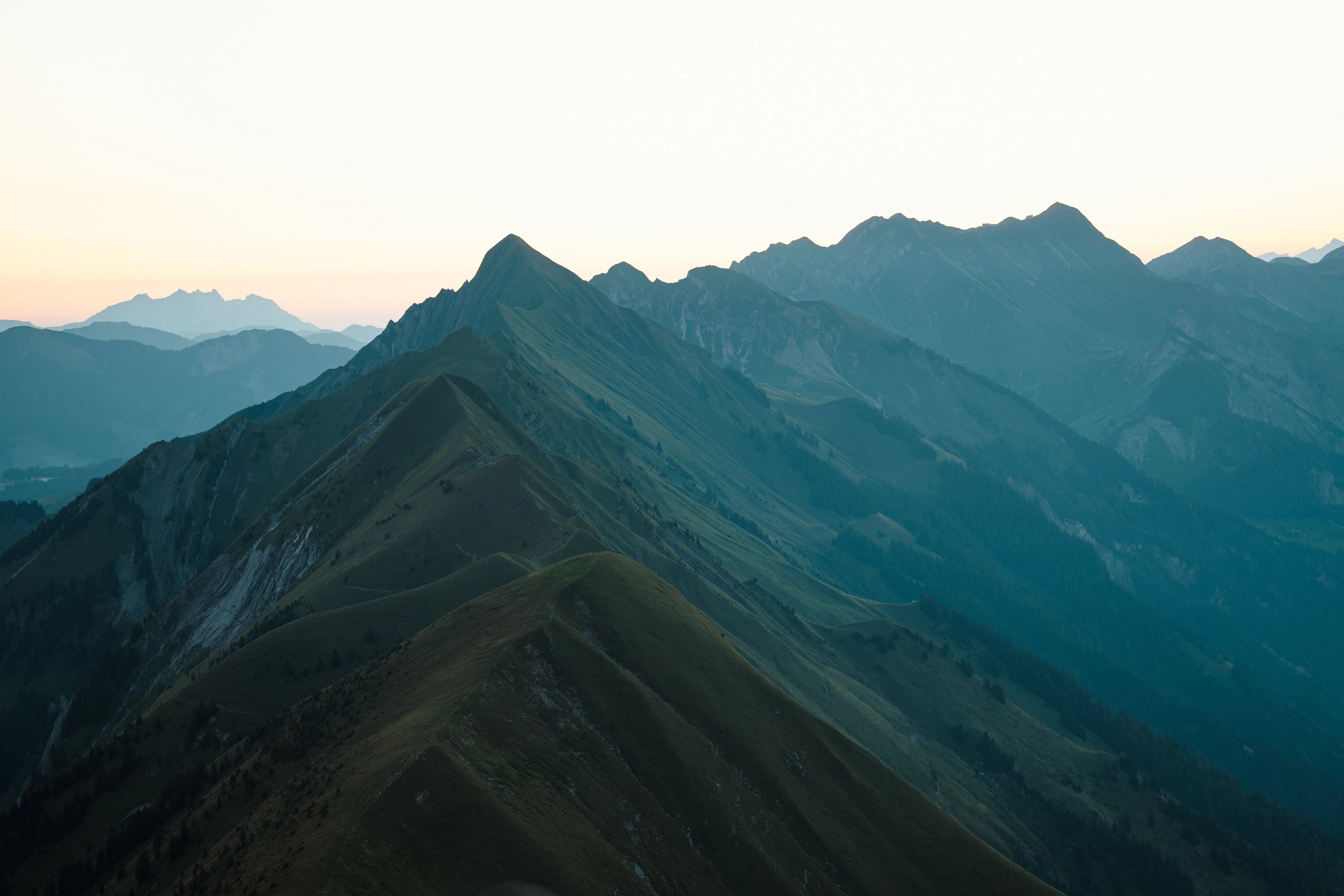 Green mountain ridges under a pale sky.