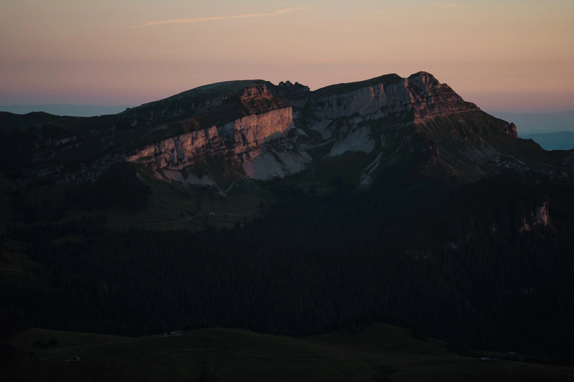 Mountain range with striped cliffs at sunrise