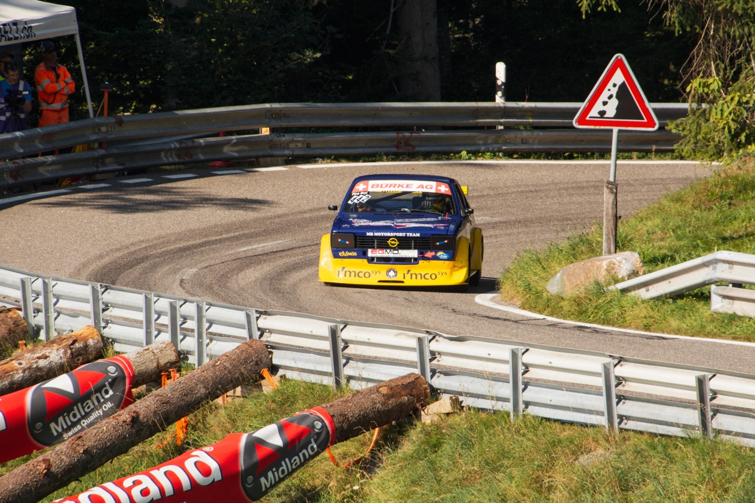 Blue Citroen race car with yellow accents driving on a track.